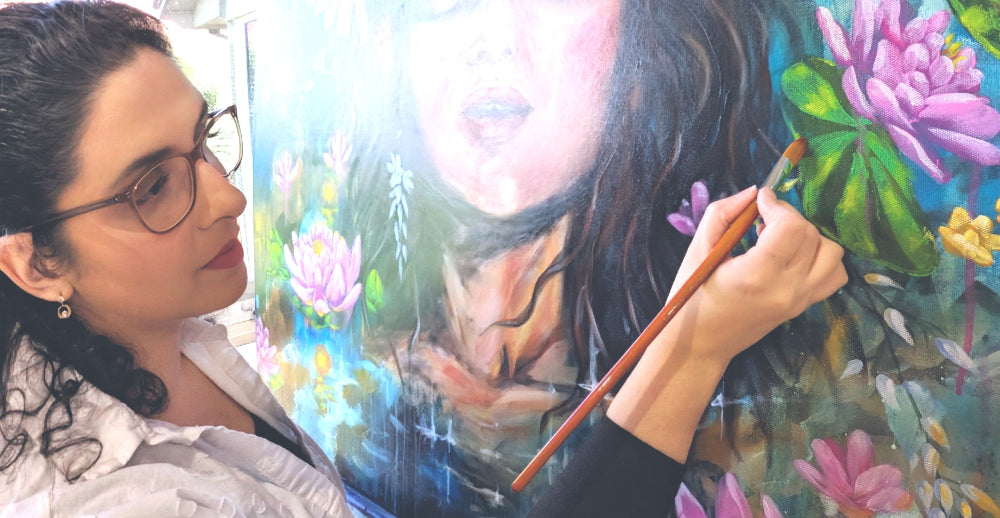 Luna Burlo painting a colorful floral scene with a brush