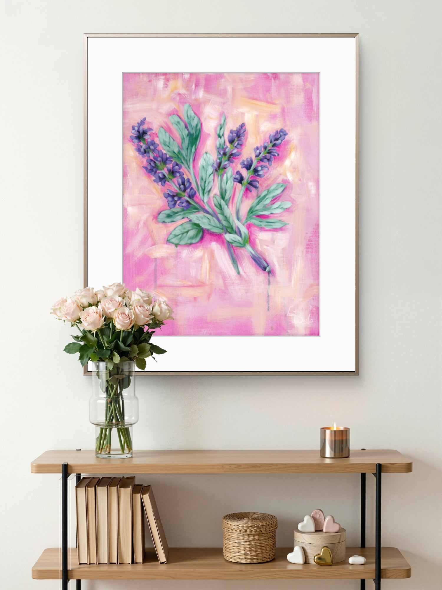 Framed floral Luna Burlo artwork of Sage on a wall above a wooden console table with books and decorative items.