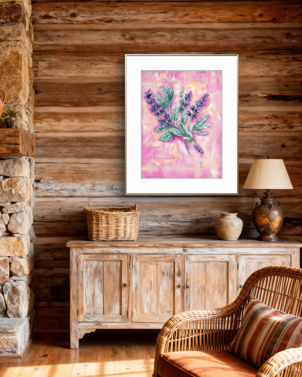 Living room with wooden walls, stone fireplace, wicker chair, and framed Luna Burlo artwork.