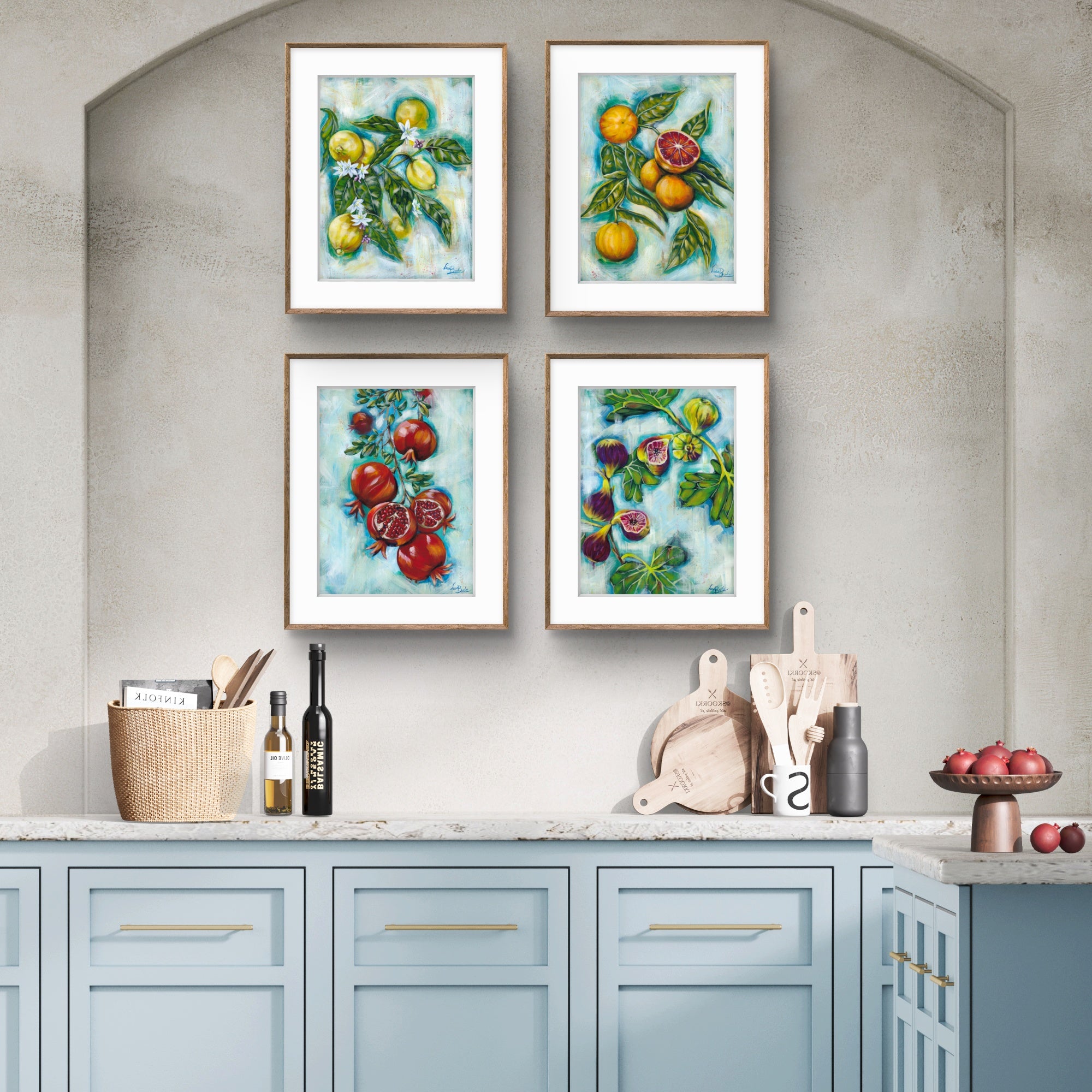 Kitchen with light blue cabinets and framed Luna Burlo artwork of fruits on a gray wall.