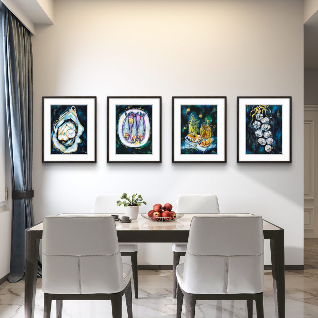 Dining room with a table and chairs, and four framed Luna Burlo artworks on the wall.