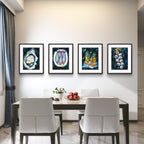 Dining room with a table and chairs, and four framed Luna Burlo artworks on the wall.