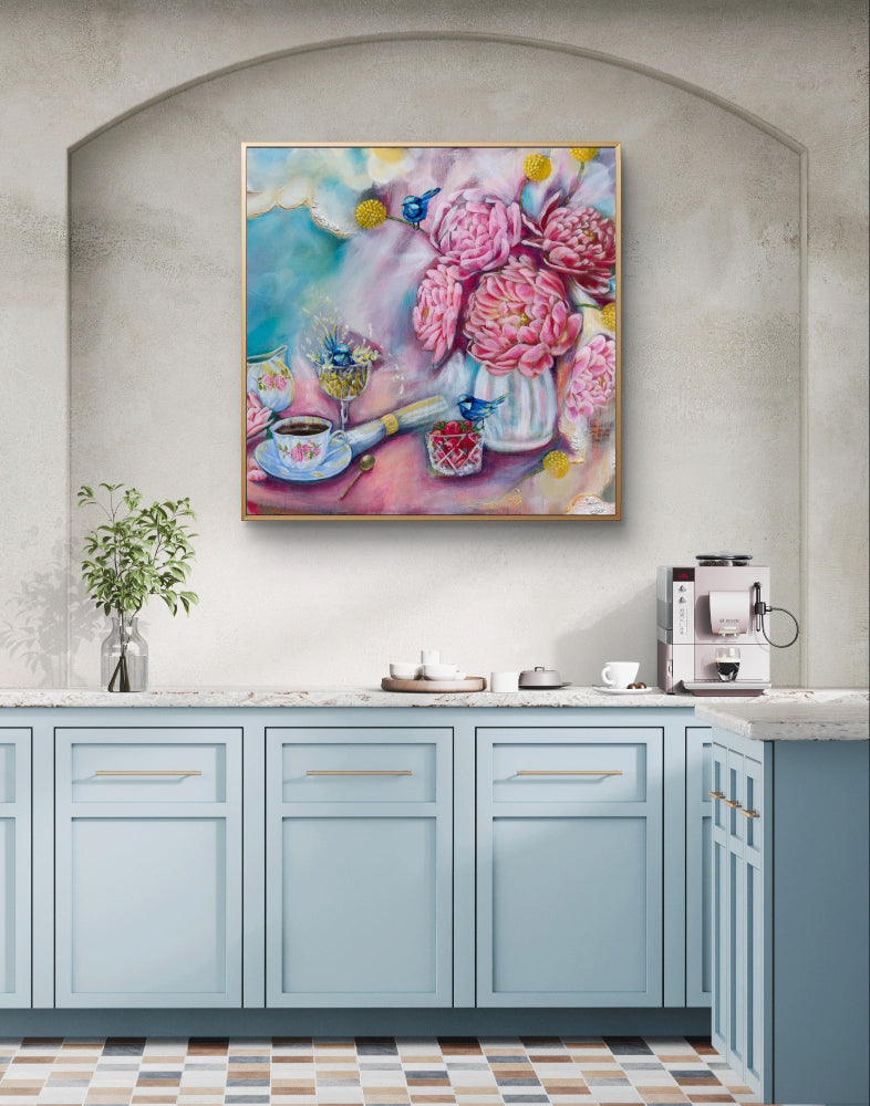 Colorful floral painting above a kitchen counter with cabinets and appliances.