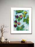 Framed Luna Burlo artwork of figs and leaves on a wall above a wooden console table.