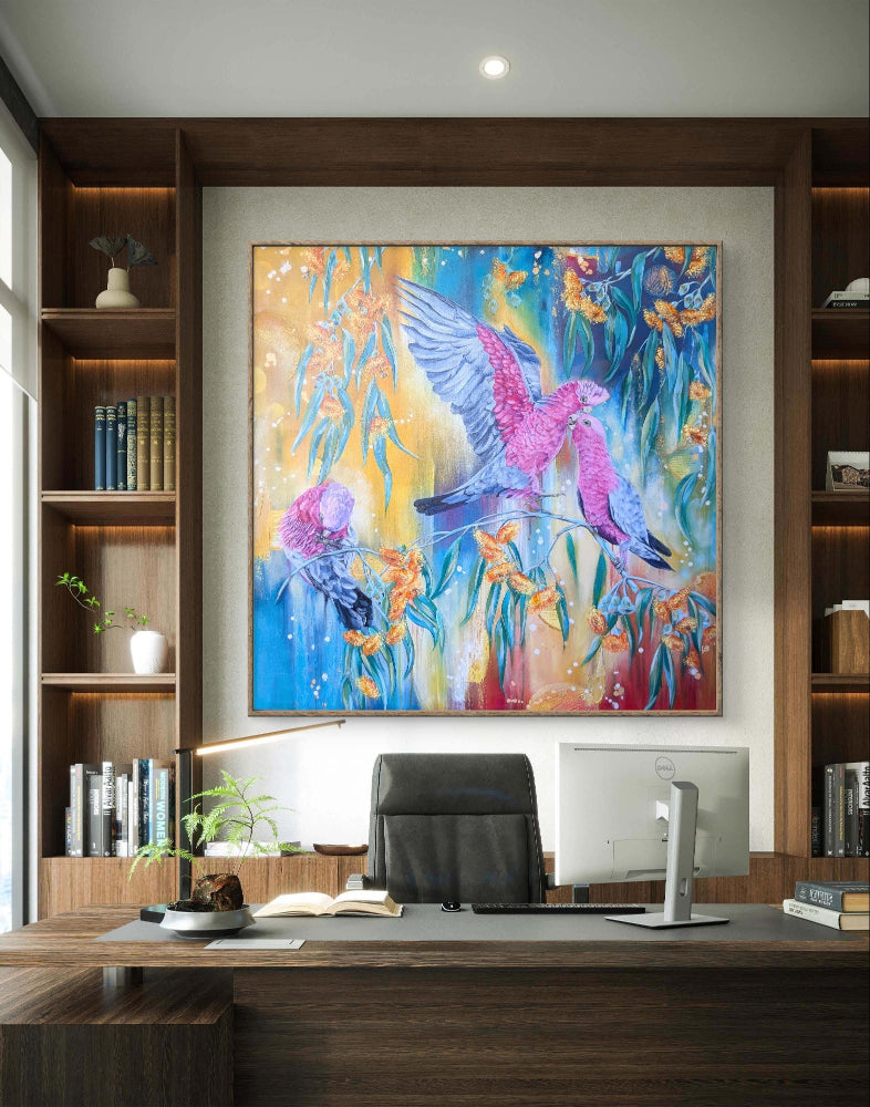 Colorful abstract painting of a bird on a wall above a desk in a home office.