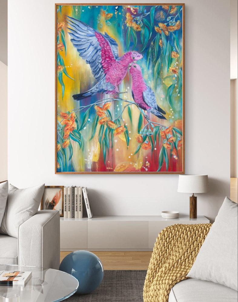 Colorful Luna Burlo fine art canvas print of Australian native galah bird painting with bright blue, yellow, red background on a wall in a living room. Art by Lunba Burlo, Melbourne, Australia