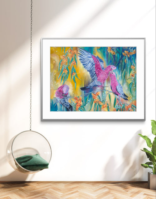Framed canvas print artwork of Australian pink galah birds and native eucalyptus flowers in a modern interior setting. Art by Luna Burlo, Melbourne, Australia
