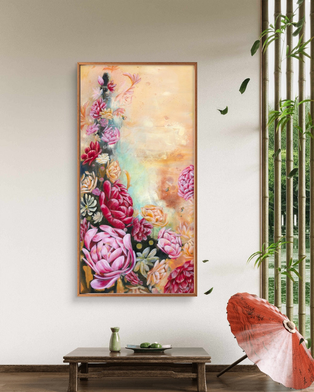 Framed abstract floral painting on a wall in a room with a table and umbrella. Colours: neutral beige, red, pink peonies. Artist, Luna Burlo, Melbourne, Australia