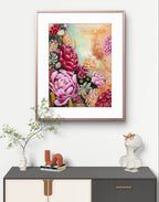 Framed red and pink peony floral fine art canvas print with black and neutral background painting on a wall above a console hallway table with decorative items. Painting also features Native Australian flowers and blue banded bees. Art by Luna Burlo, Melbourne, Australia