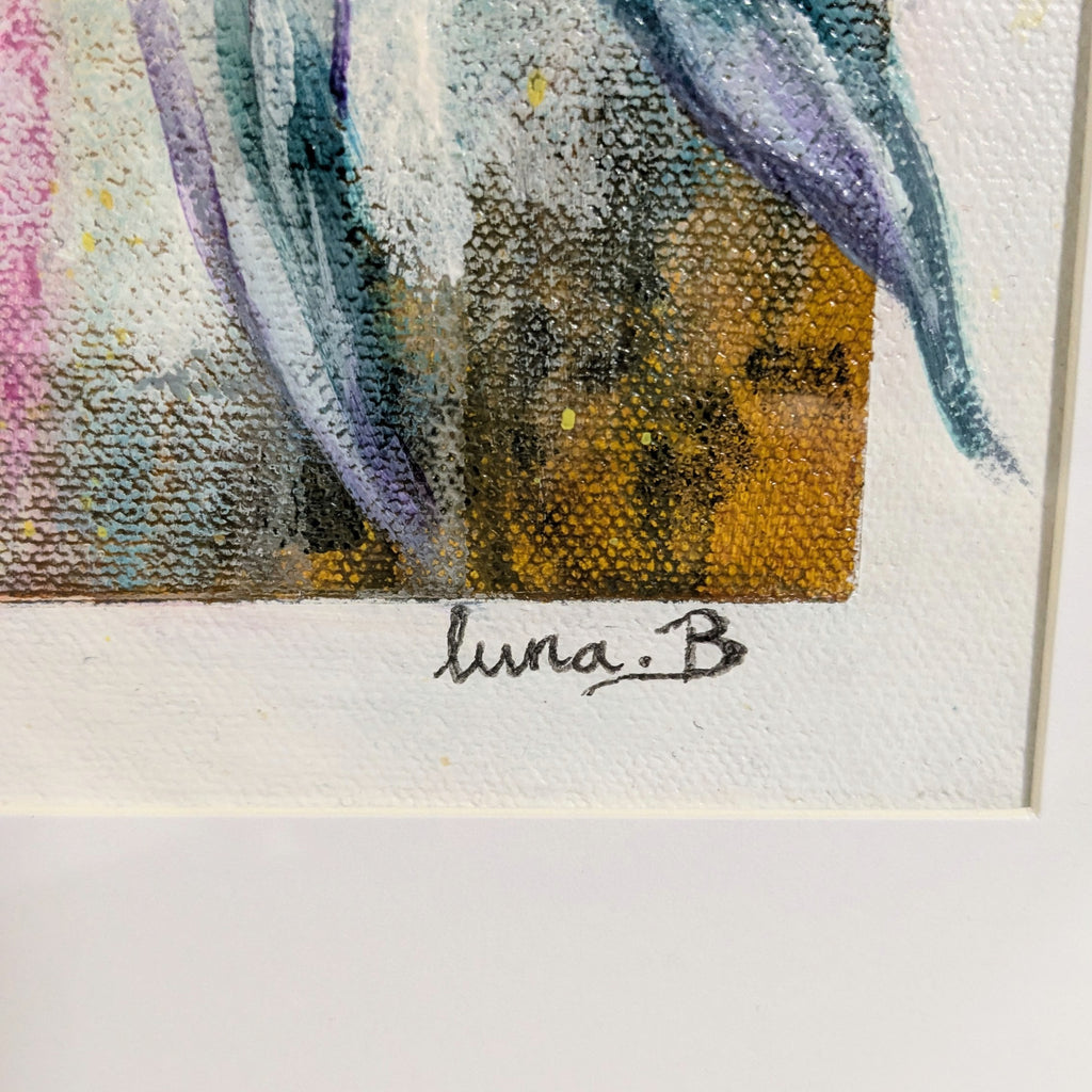 Close-up of Luna Burlo signature on a piece of art with colorful abstract painting in the background