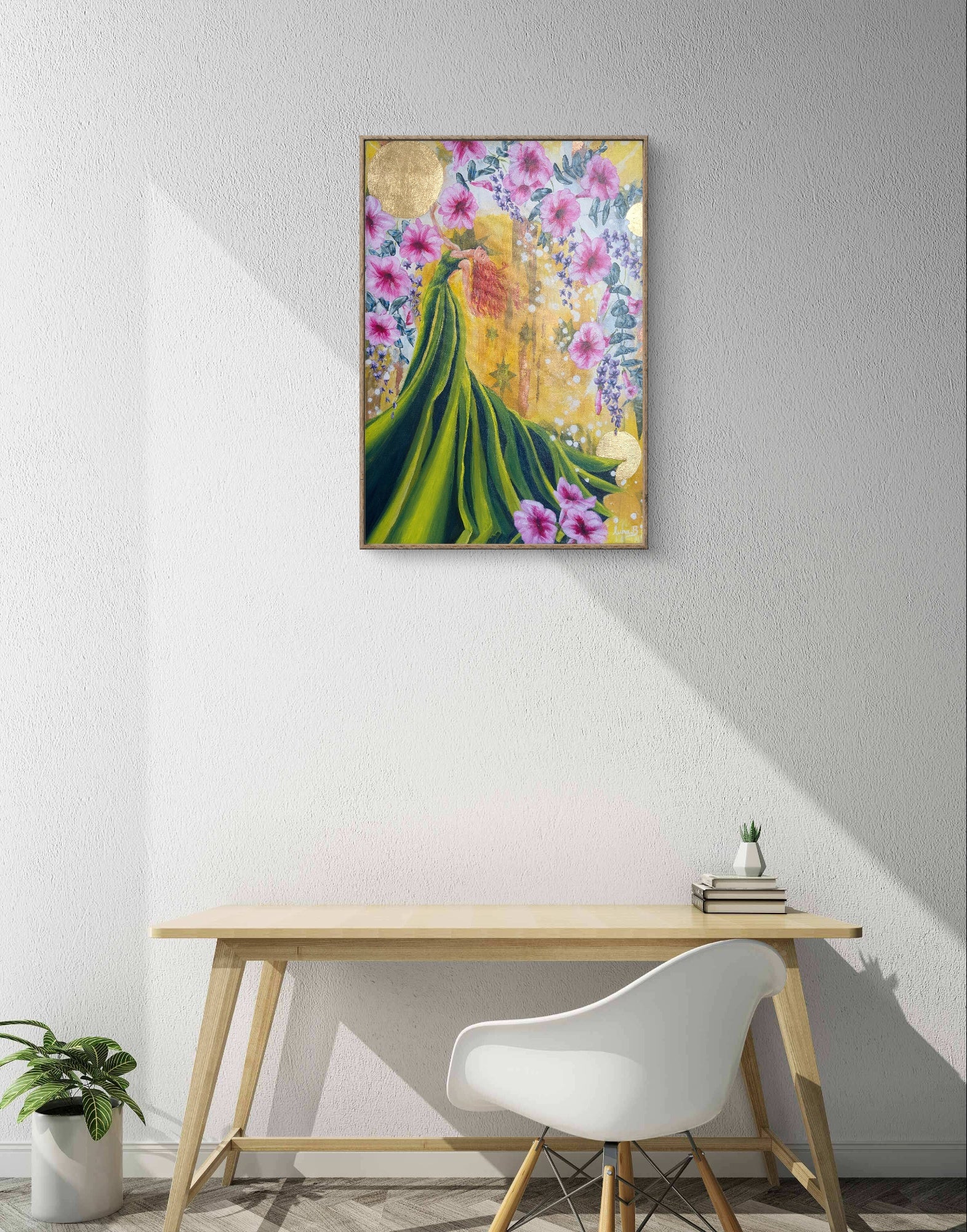Colorful abstract Luna Burlo painting or fine art print on a wall above a wooden table desk with a white chair.