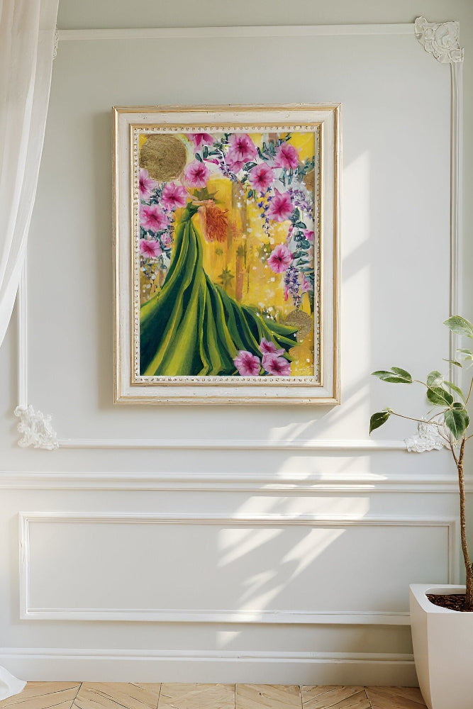 Framed mixed media artwork of a woman in a green dress on a yellow background with pink native Australian pandorea flowers and gold leaf details on a classic white wall. Art by Luna Burlo and made in Melbourne, Australia