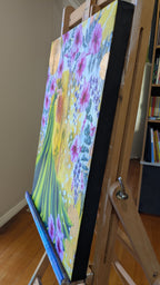 Luna Burlo Flourish colorful floral painting on an easel in a room with books.