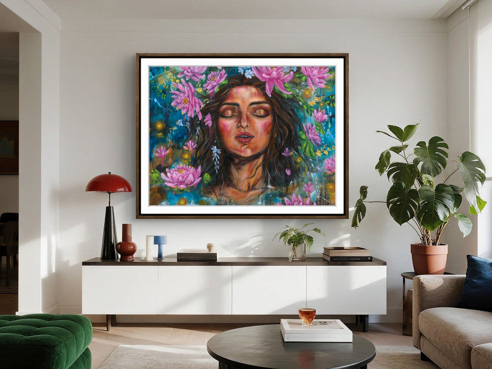 Living room with a  large rectangle colorful painting of a woman's face surrounded by pink water lily flowers on a blue background on the wall. Artist: Luna Burlo, Melbourne, Australia