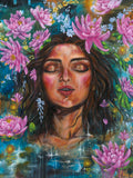 Vertical portrait orientation fine art canvas print of a woman's face surrounded by pink lotus and lukspur July birth month flowers, on a blue background. Artist: Luna Burlo, Melbourne, Australia