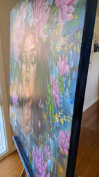 Luna Burlo origianl acrylic painting of a woman with lotus and lukspur flowers on an easel indoors. Side view. Melbourne, Australia