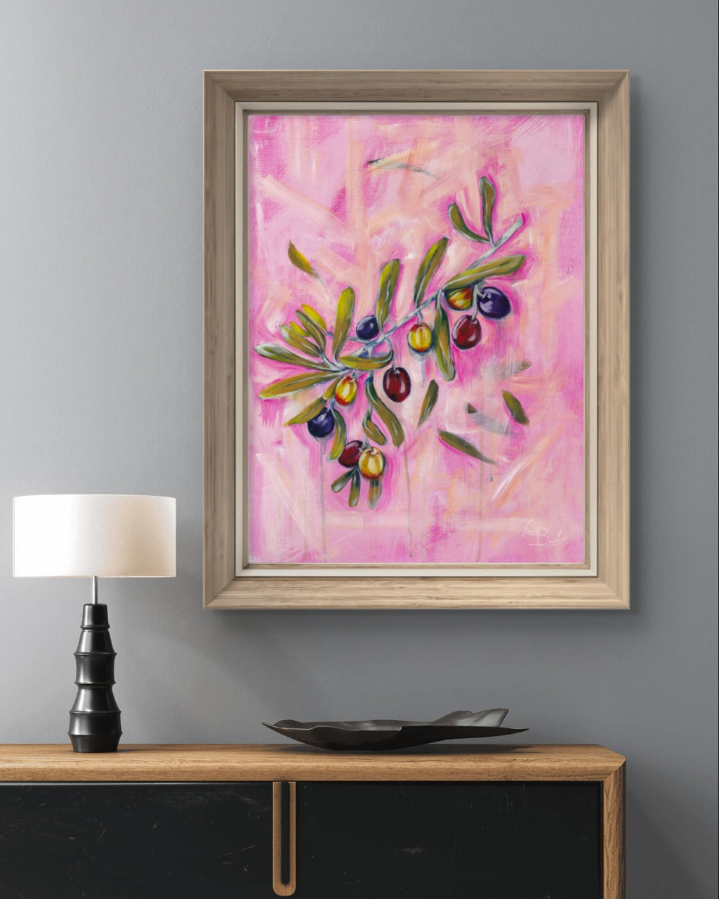 Framed Luna Burlo abstract painting on a gray living room wall above a wooden console table with a lamp and decorative bowl.

Fine art paper print or her original acrylic artwork of "Olives" from series "Mediterranean Table".

Colorful abstract food art with dark purple, deep red, and rich yellow fruit, and green leaves on a textured pink background. Rectangle vertical or portrait orientation. Made in Melbourne, Australia