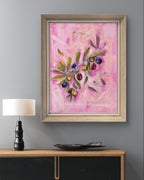 Framed Luna Burlo abstract painting on a gray living room wall above a wooden console table with a lamp and decorative bowl.

Fine art paper print or her original acrylic artwork of "Olives" from series "Mediterranean Table".

Colorful abstract food art with dark purple, deep red, and rich yellow fruit, and green leaves on a textured pink background. Rectangle vertical or portrait orientation. Made in Melbourne, Australia