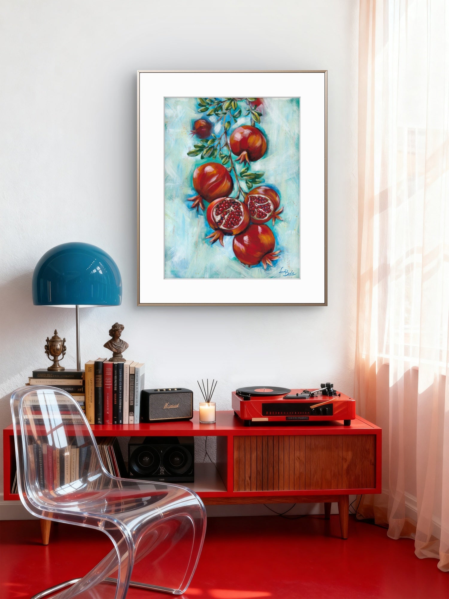 Framed Luna Burlo fine art paper print or her original artwork of pomegranates from series "Mediterranean Table" styled on a living room wall above a red console table with a clear chair and blue lamp.

Colorful abstract with red fruit and turquoise blue background. Rectangle vertical or portrait orientation. Made in Melbourne, Australia