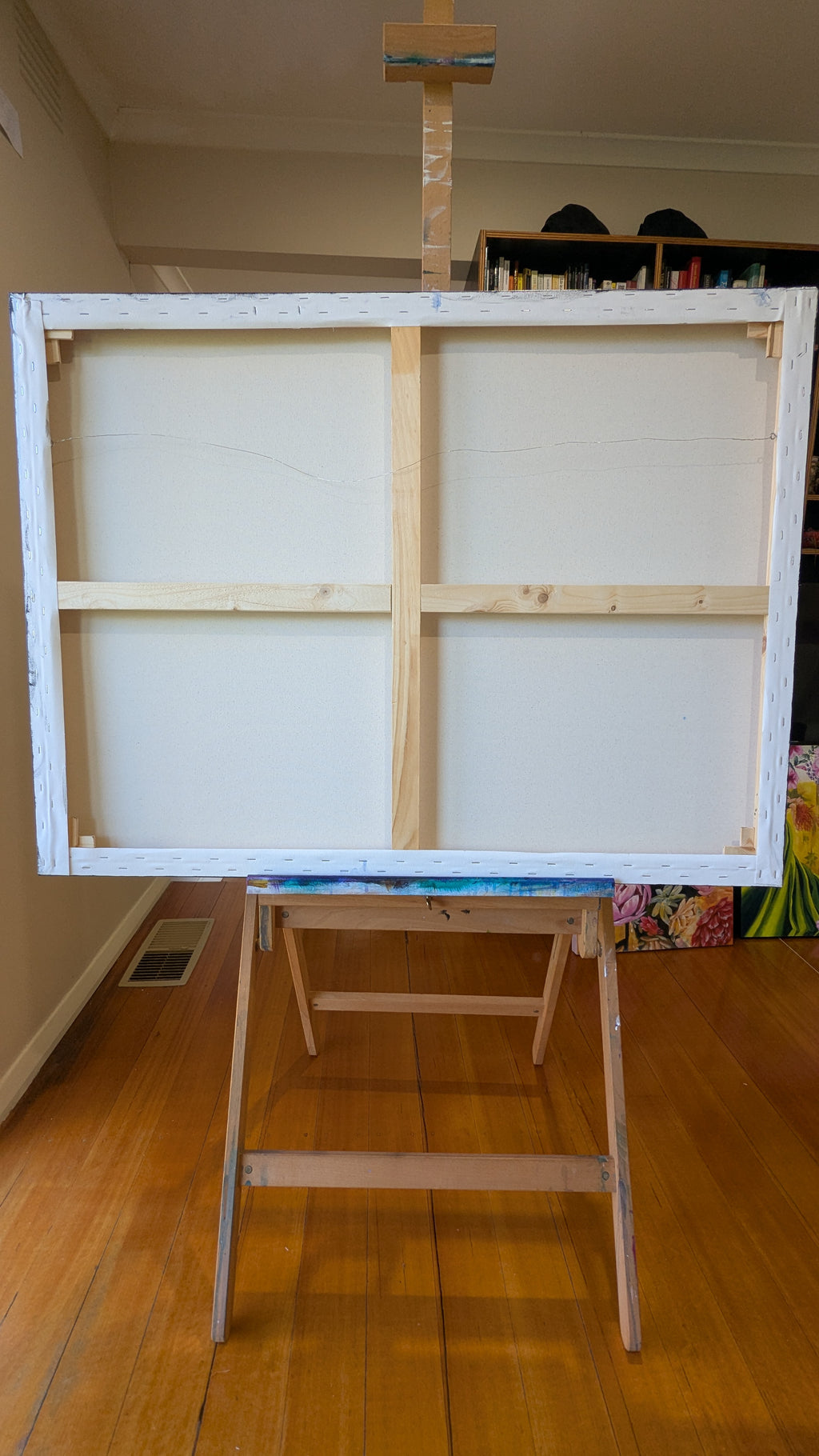 Large white canvas on an easel in a room by Melbourne artist Luna Burlo