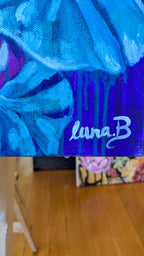 Blue textured cavas art by Luna Burlo with 'lunaB' branding signature on a wooden surface
