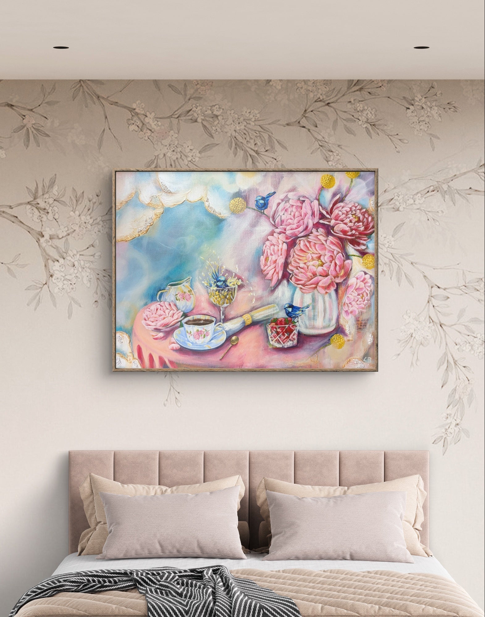 Colorful pink Luna Burlo floral painting or fine art print above a bed with decorative pillows. Bedroom art idea. Australia