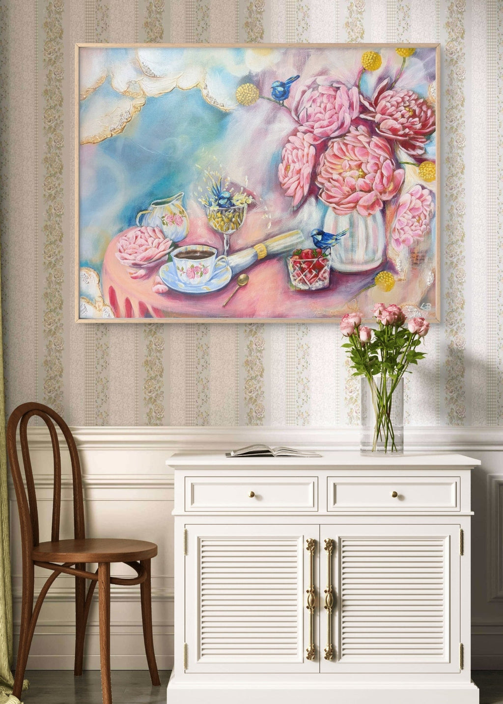 Decorative interior with a colorful Luna Burlo painting of peony and Billy Button flowers and a teacup, a wooden chair, and a white cabinet/desk. Melbourne, Australia