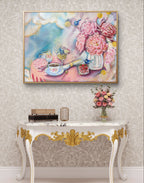 Decorative console table with a pink and blue Luna Burlo floral painting or fine art print above it on a wall. Australia.